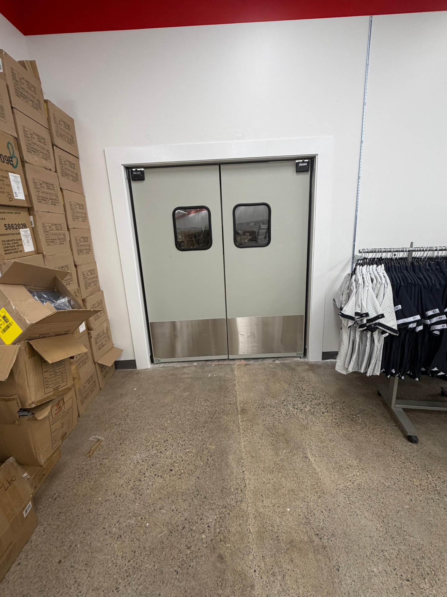 After — completed drywall, paint and stockroom doors in a finished Toronto retail store